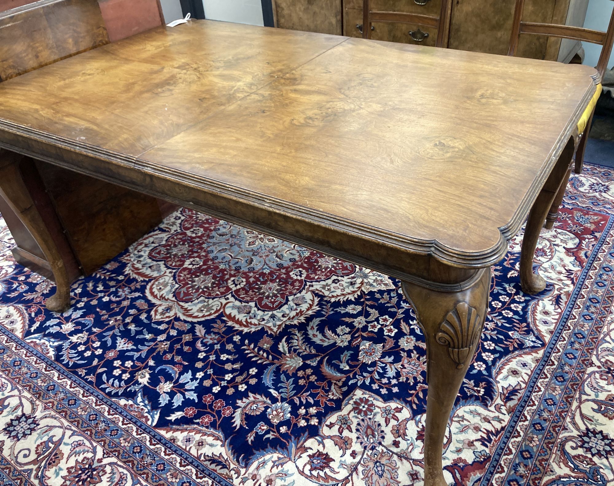 A Queen Anne revival walnut extending dining table, length 182cm extended (one spare leaf), width 90cm, height 74cm